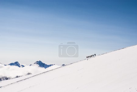 Climbing climbers on the snowy mountain top. Dream line.