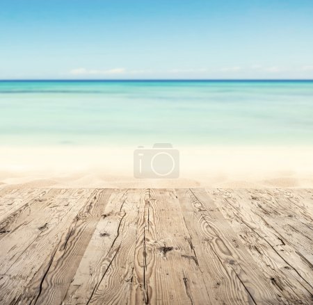 Empty wooden pier with view on sandy beach