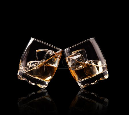 Glasses of whiskey on black background