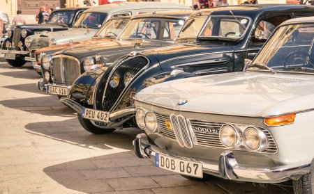 MDINA, MALTA - OCTOBER 10, 2014: vintage classic retro cars parked in San Pawl square. The ancient capital Mdina is a medieval walled town situated on a hill in the centre of the island