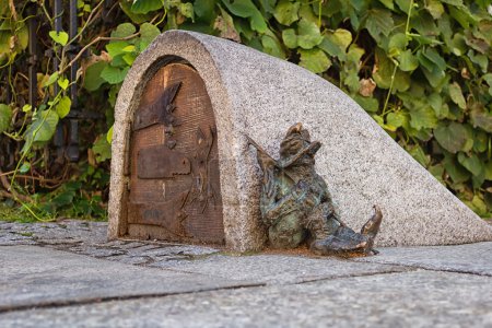 Dwarf guards the entrance of a small building