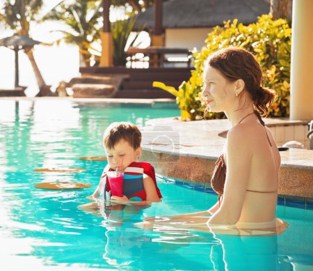 child with mother by the pool 