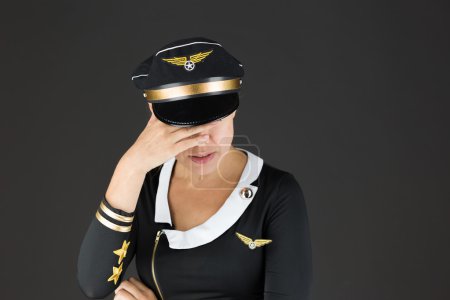 Air hostess ashamed hiding face in hand