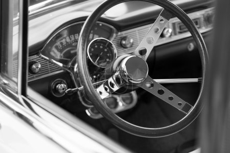 Black steering wheel of a classic car