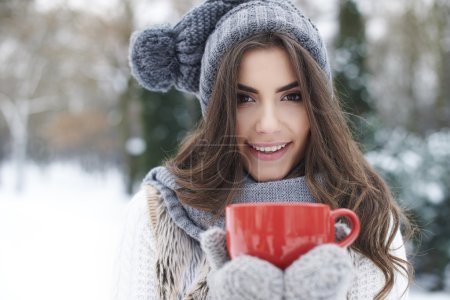 Winter woman with cup of hot tea