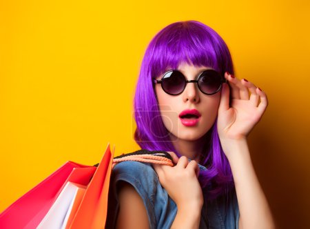 Women with violet hair with shopping bags.