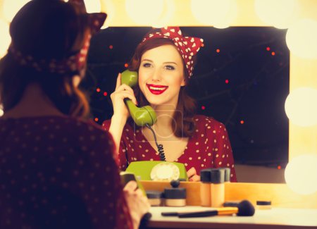woman with dial phone applying cosmetics
