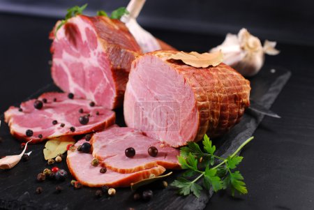 pieces of homemade smoked pork ham on black background