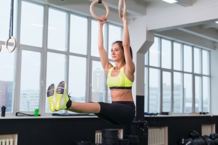 woman exercising with gymnastic rings