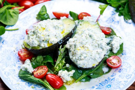 Avocado halves stuffed with cottage cheese and vegetables