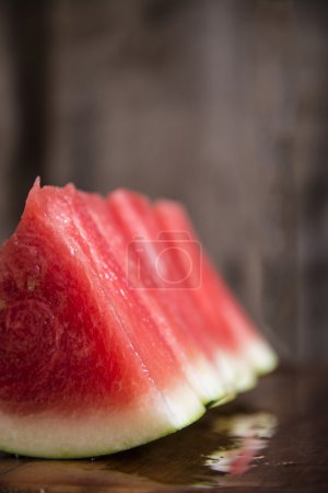 Sliced juicy watermelon on wooden chopping board
