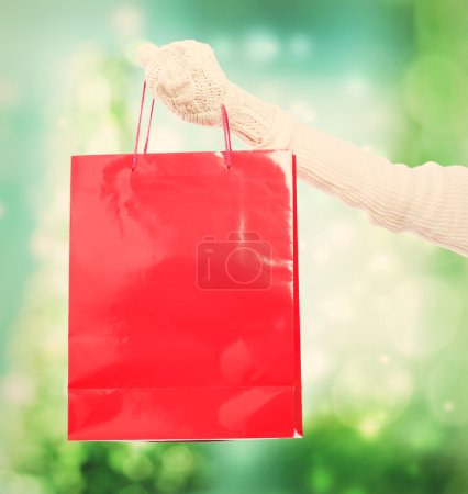 Woman holding a big red shopping bag 