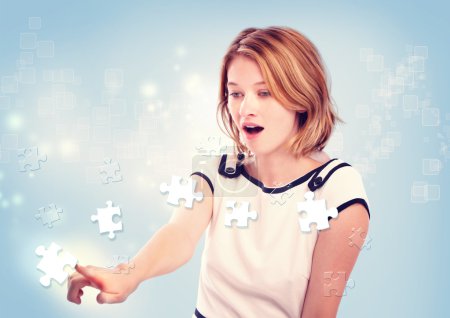 Young woman pointing to the key puzzle piece