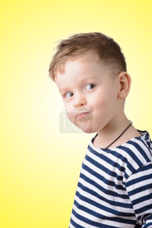 little boy in a striped vest on a yellow background