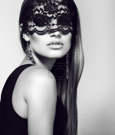 sexy woman in lace mask with luxurious straight hair 