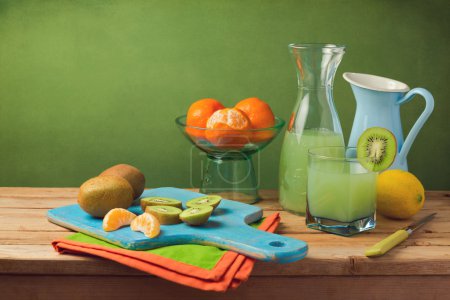 Fruits and juice on wooden table