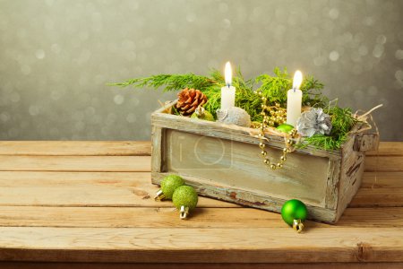 Box with Christmas decorations and candles