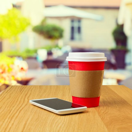 Coffee cup and mobile phone