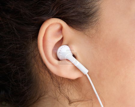 Young woman ear with earphone 