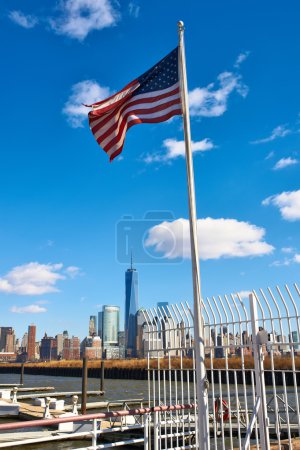 American flag with Manhattan skyline at background 