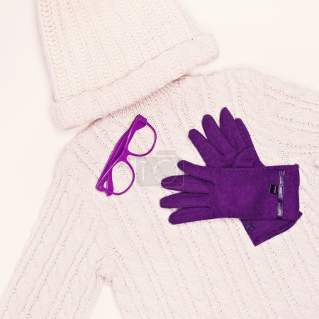 White knit sweater and cap in combination with purple gloves. Wi