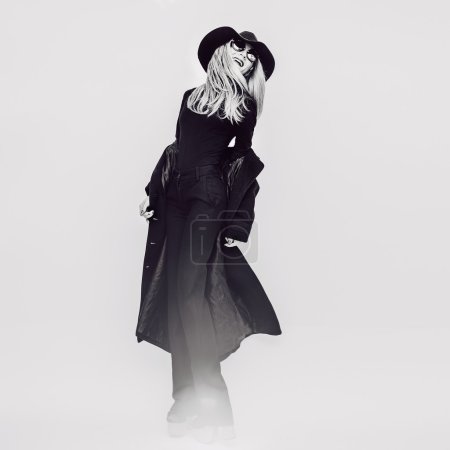 Happy Glamorous lady in a black coat and hat. Black and white vi