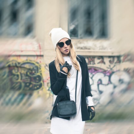 Glamorous blonde on the street. Urban fashion black and white