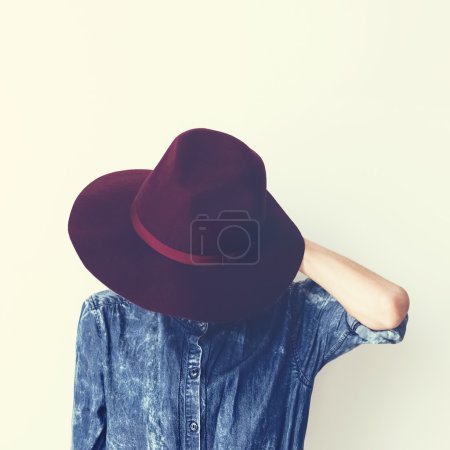 Glamorous fashion lady in a stylish denim shirt and hat. Vintage