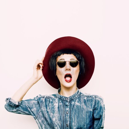 Vintage funny lady in a stylish denim shirt and hat. hipster sty