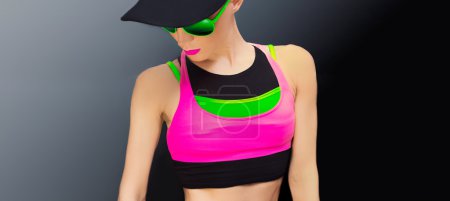 Slim athletic fitness blonde on a black background in the fashio