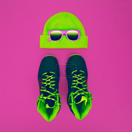 Stylish fashion sport accessories: sneakers, sunglasses, hat on 