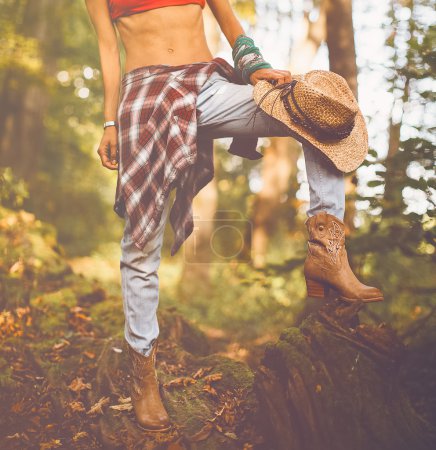 Autumn cowboy style. Cowboy boots in the woods