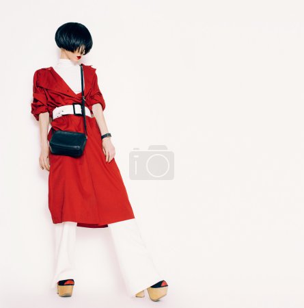 Portrait fashionable lady in a red cloak on a white background
