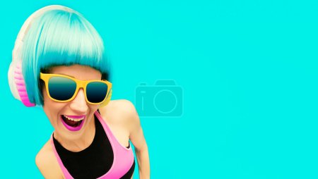 Glamorous party dj girl in bright clothes on a blue background l
