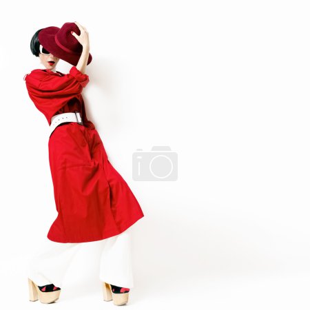 Portrait fashionable lady in a red cloak on a white background