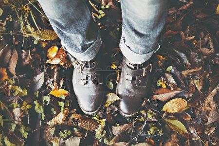 Vintage boots on fall foliage