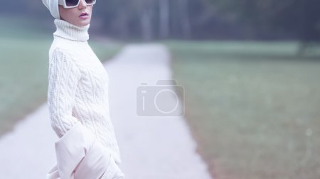 Portrait stylish lady in white glamorous clothes. Fall Winter fa