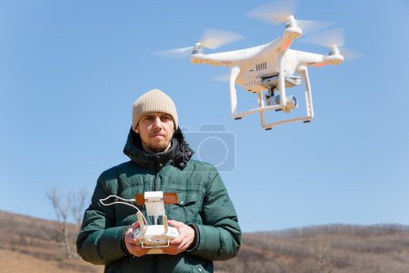 Man controls the flying drones