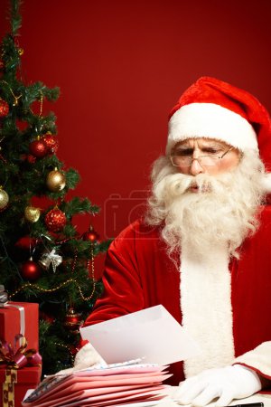 Santa Claus reading wish letter
