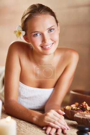 Young female relaxing in spa salon