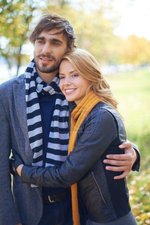 Couple embracing in autumn park