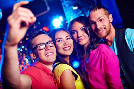 People taking selfie at party