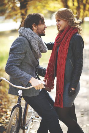 Couple with bicycle  in autumn park