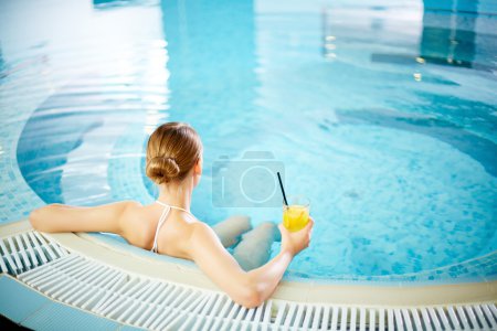 Pretty girl relaxing in swimming pool