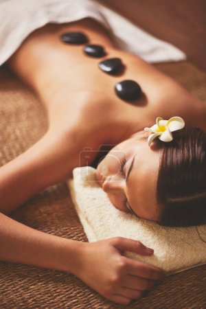 Young female lying in spa salon