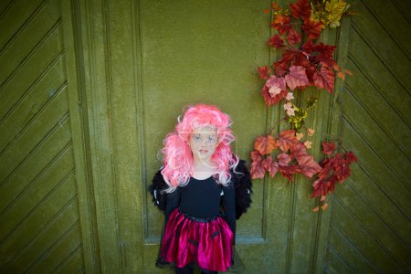 Girl wearing Halloween attire and pink wig