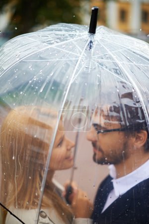 Affectionate couple under umbrella