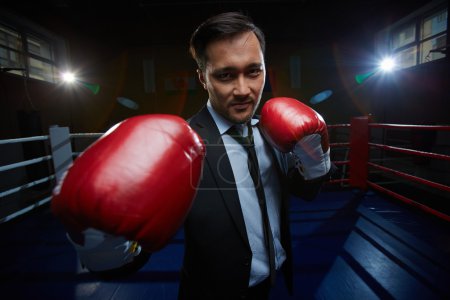 Businessmen in suit and boxing gloves