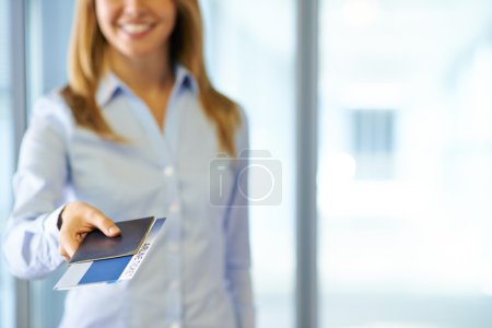 Office worker passing passport and ticket
