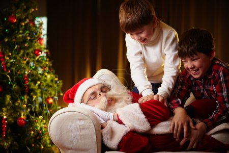Boys trying to wake Santa up